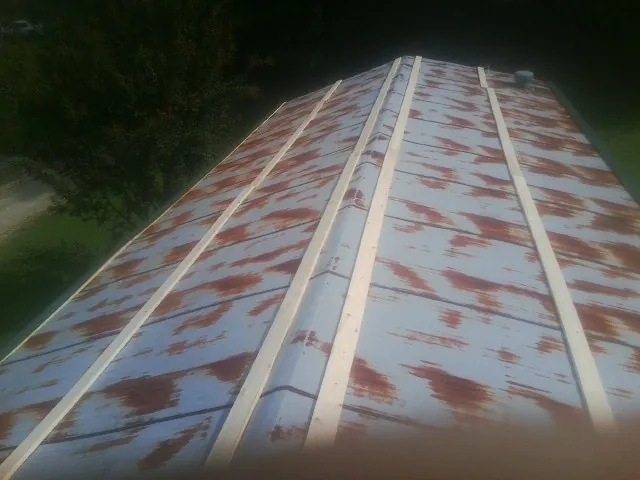 Rusted metal roof panels with new wood purlins before replacement — Storm Damage Roof Repair in Irwin by Roofing Brothers