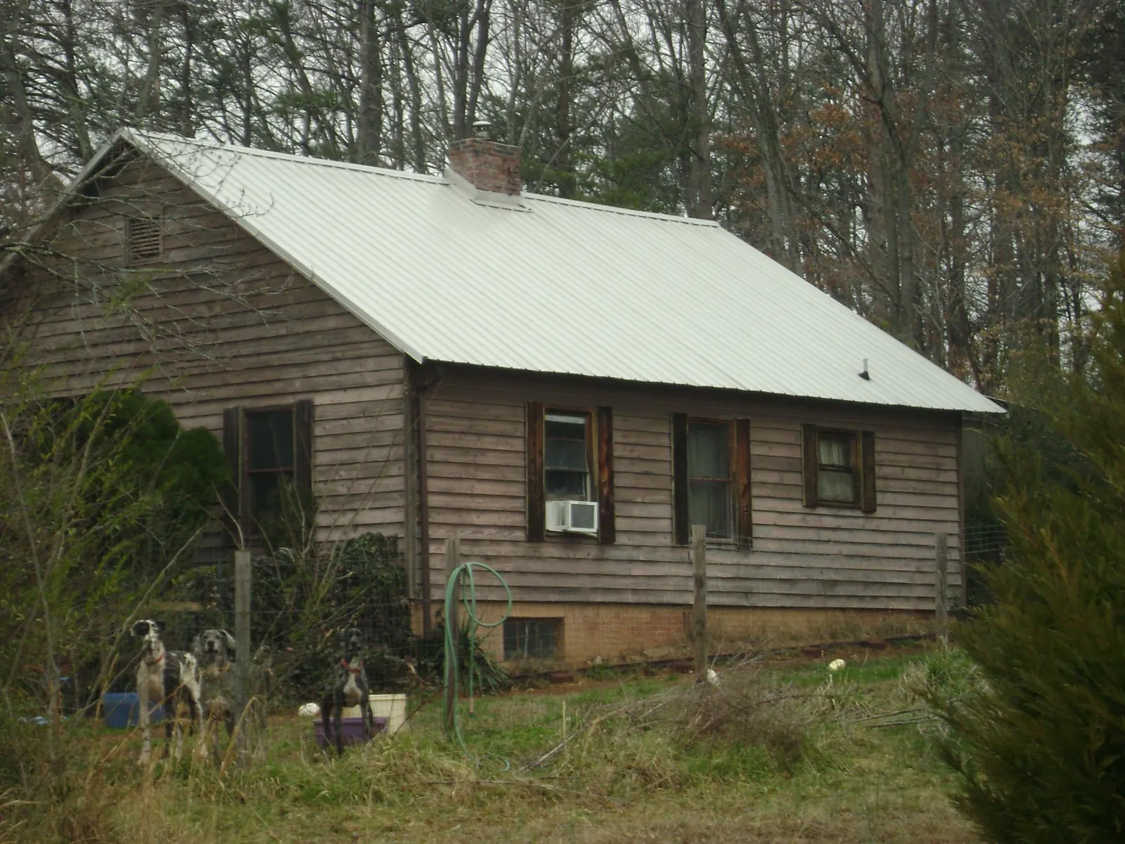 White metal roof on an old wood sided farmhouse, from a Metal Roof Installation job in Irwin